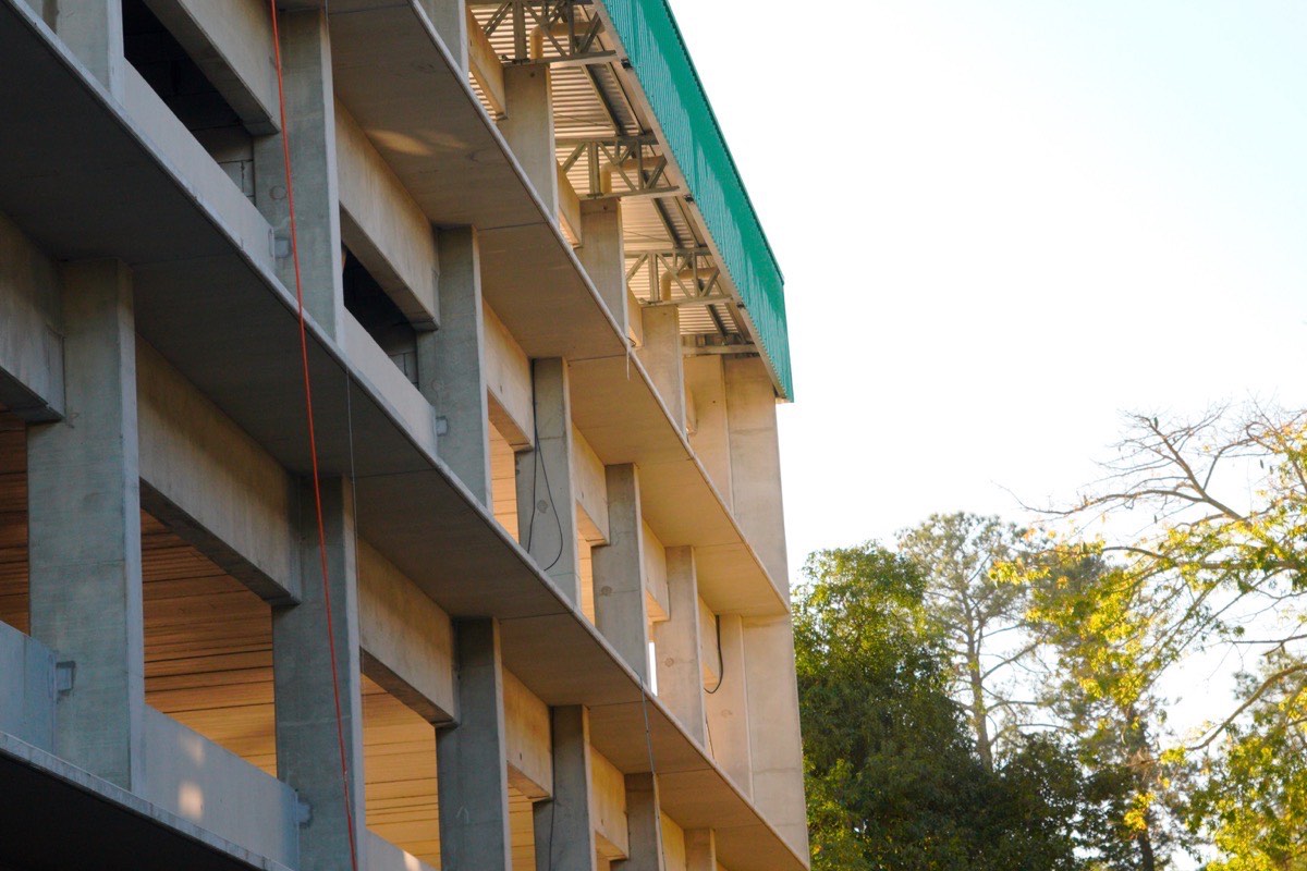Obra comercial em construção em Criciúma, com estrutura de prédio erguida e equipe de engenharia acompanhando a execução